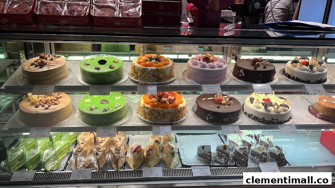 A vibrant display case showcasing a wide variety of beautifully decorated cakes and pastries.