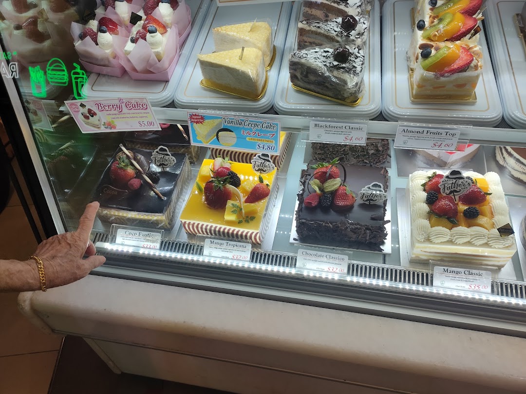 A vibrant display case showcasing a variety of beautifully decorated cakes and pastries.