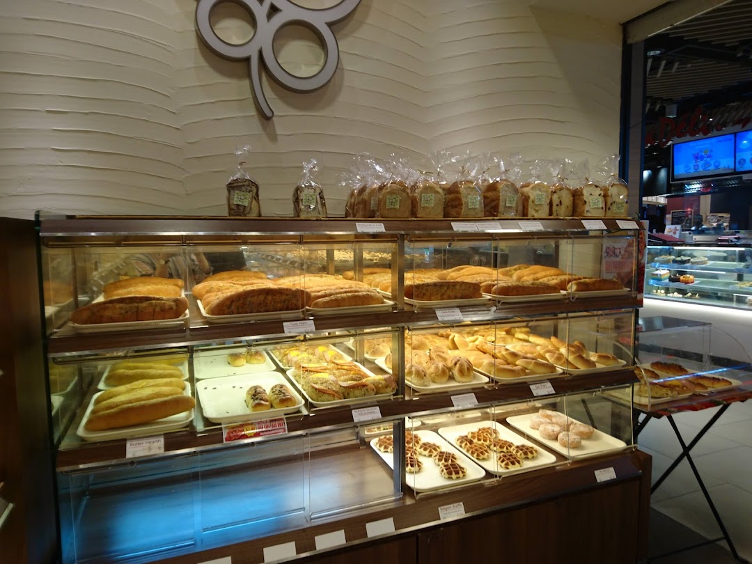 A display of freshly baked bread, pastries, and other treats inside a Four Leaves bakery.