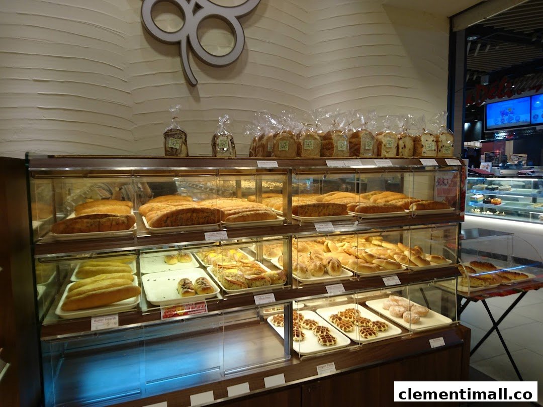 A display of freshly baked bread, pastries, and other treats inside a Four Leaves bakery.