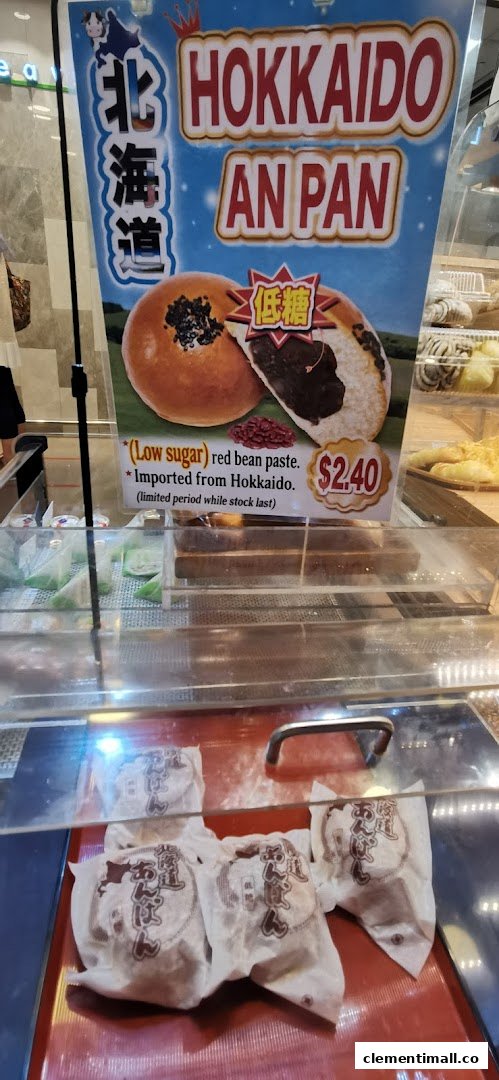A display of Hokkaido An Pan pastries with a promotional sign highlighting their low-sugar red bean paste and origin.