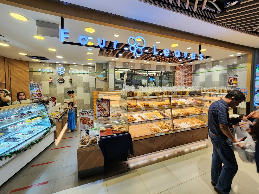 Interior view of Four Leaves bakery showcasing a wide array of freshly baked breads, pastries, and cakes.