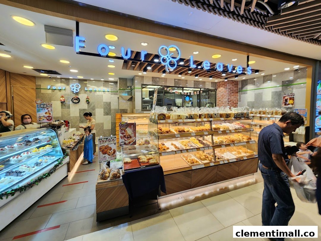 Interior view of Four Leaves bakery showcasing a wide array of freshly baked breads, pastries, and cakes.