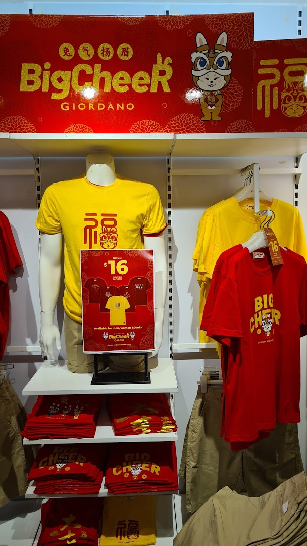 A vibrant retail display at Giordano showcasing their 'Big Cheer' collection of red and yellow festive apparel.
