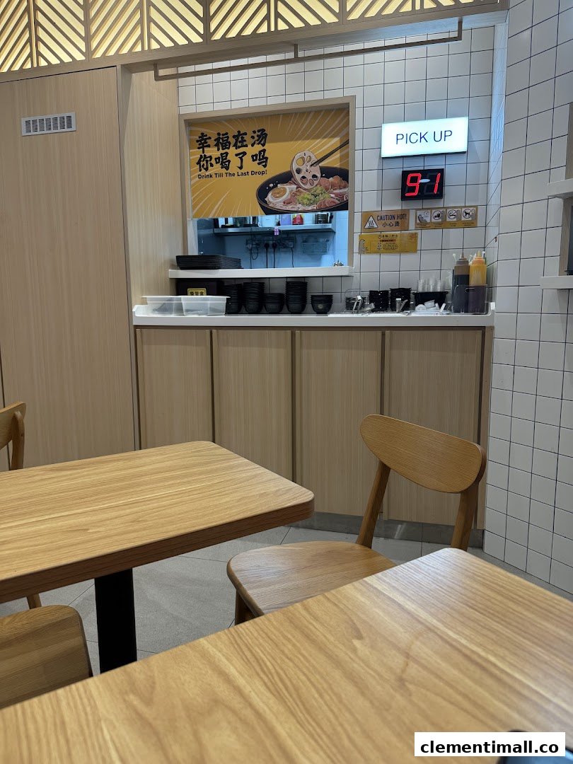 Interior view of Gong Yuan Ma La Tang showing dining area, pick-up counter, and promotional poster.
