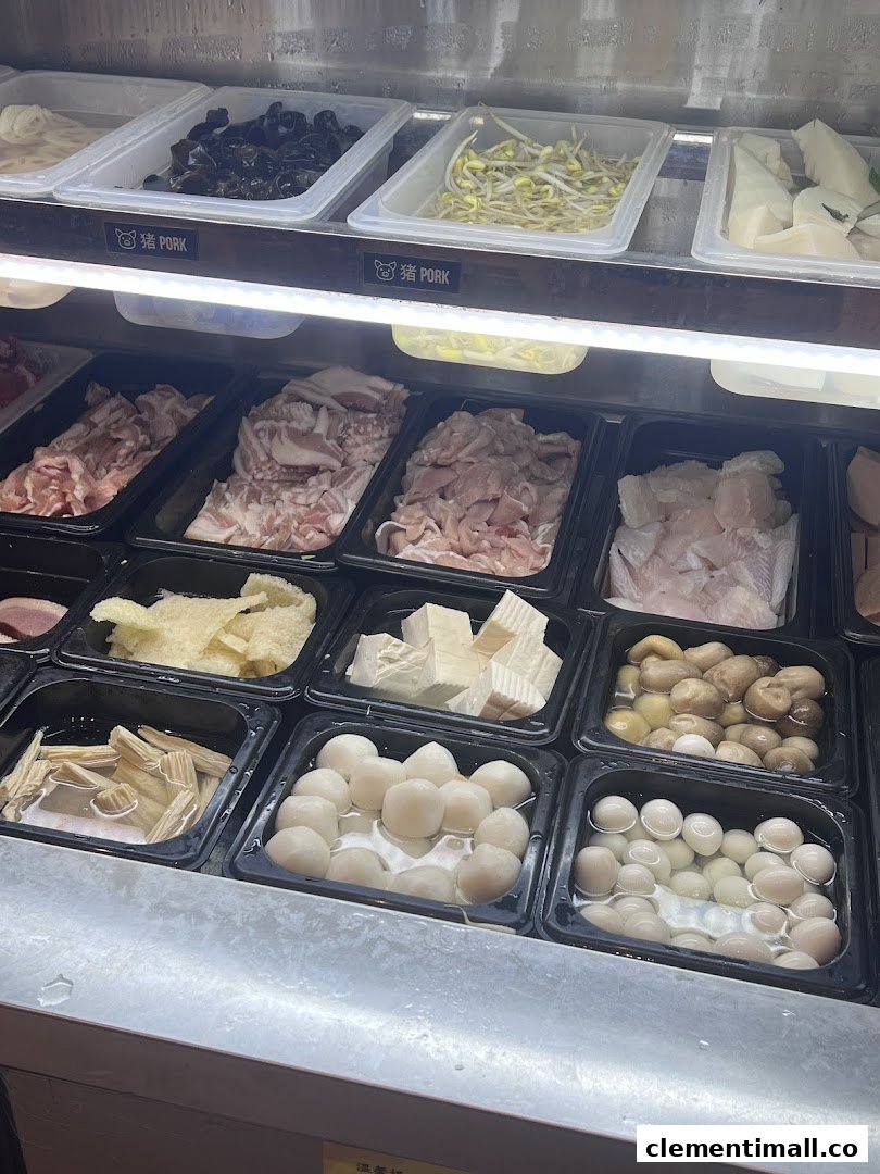 A vibrant display of fresh ingredients for custom mala tang, including meats, vegetables, and various balls.