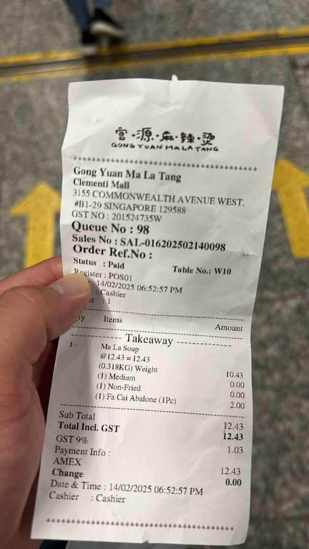 A close-up of a receipt from Gong Yuan Ma La Tang showing a takeaway order for Ma La Soup and Fa Cai Abalone.