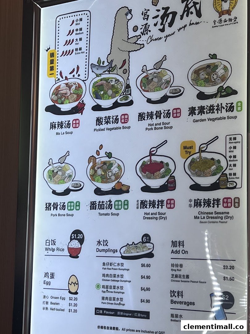 A brightly lit menu board for Gong Yuan Ma La Tang, showcasing various soup bases, side dishes, and beverages.