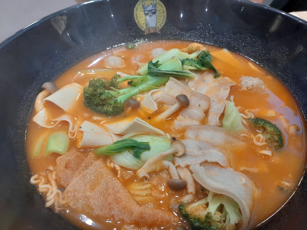 A vibrant bowl of Mala Tang with assorted ingredients like meat, vegetables, and noodles.