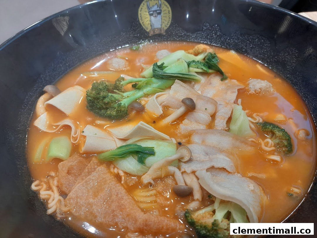 A vibrant bowl of Mala Tang with assorted ingredients like meat, vegetables, and noodles.