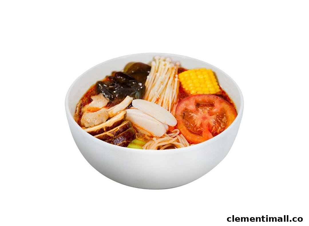 A vibrant bowl of Ma La Tang featuring various ingredients like mushrooms, corn, tomato, and noodles.