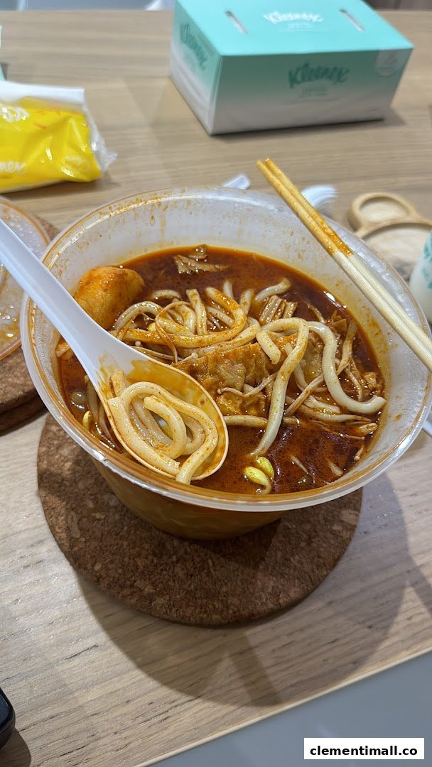 A close-up of a vibrant bowl of spicy Mala Tang noodle soup with various ingredients.