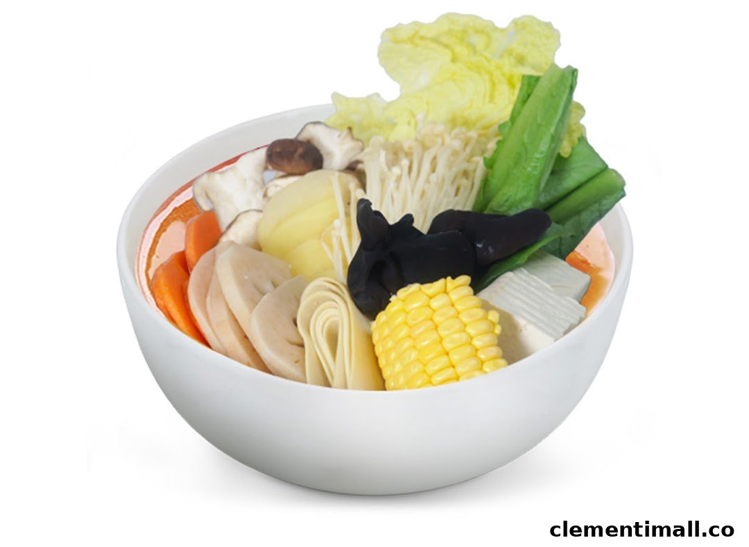 A vibrant bowl of Mala Tang ingredients including vegetables, mushrooms, and corn in a white bowl.