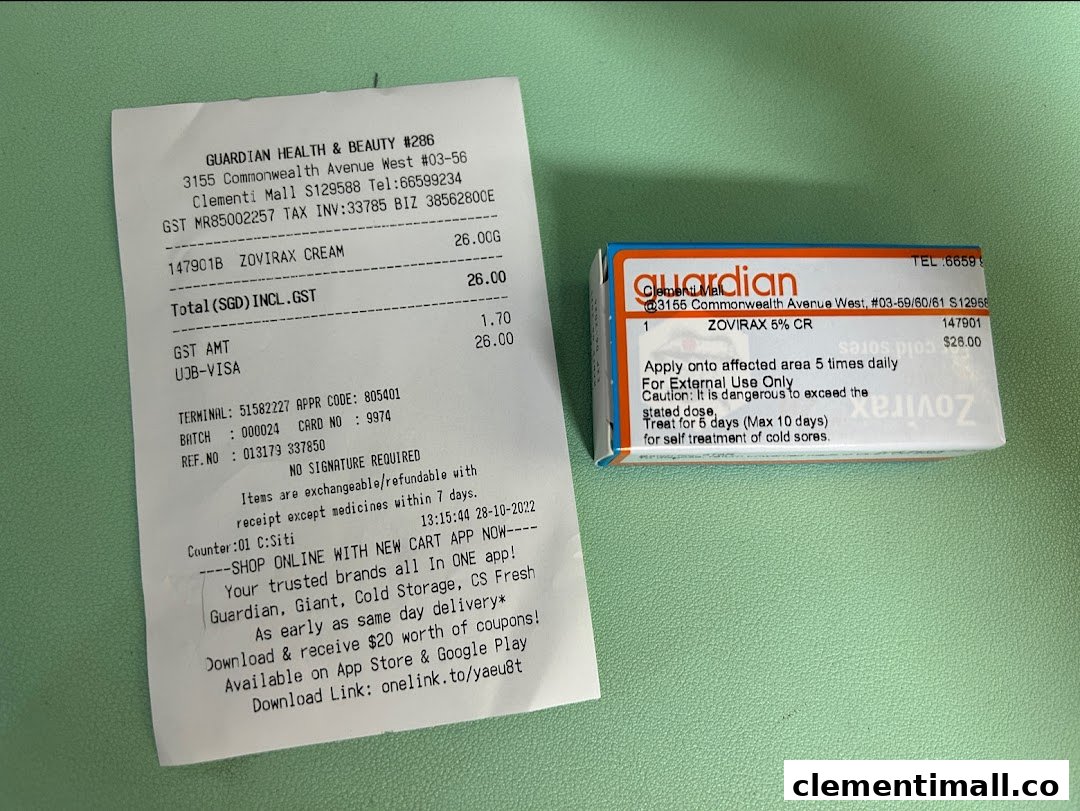 A Guardian Health & Beauty receipt and a Zovirax Cream product box are displayed on a green surface.