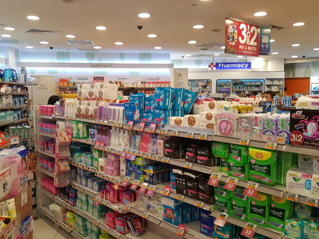 Aisle view inside Guardian, showcasing health, beauty, and personal care products with a pharmacy section.