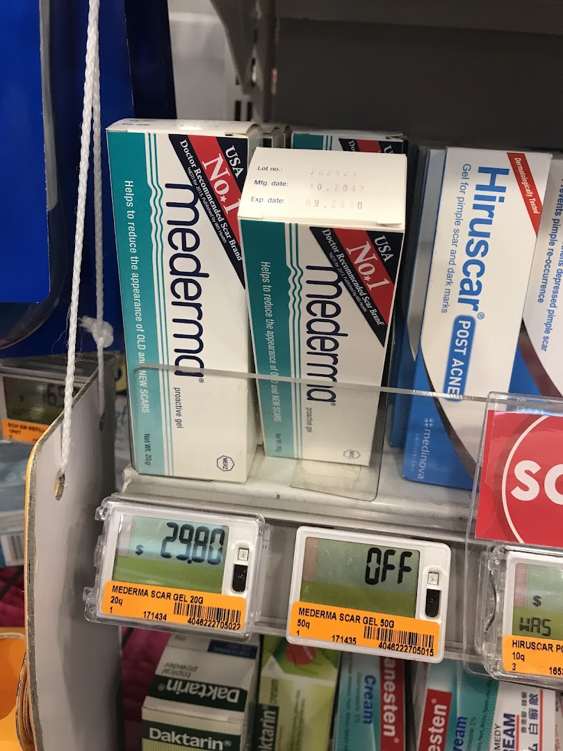 Scar treatment products like Mederma and Hiruscar displayed on a retail shelf with digital price tags.