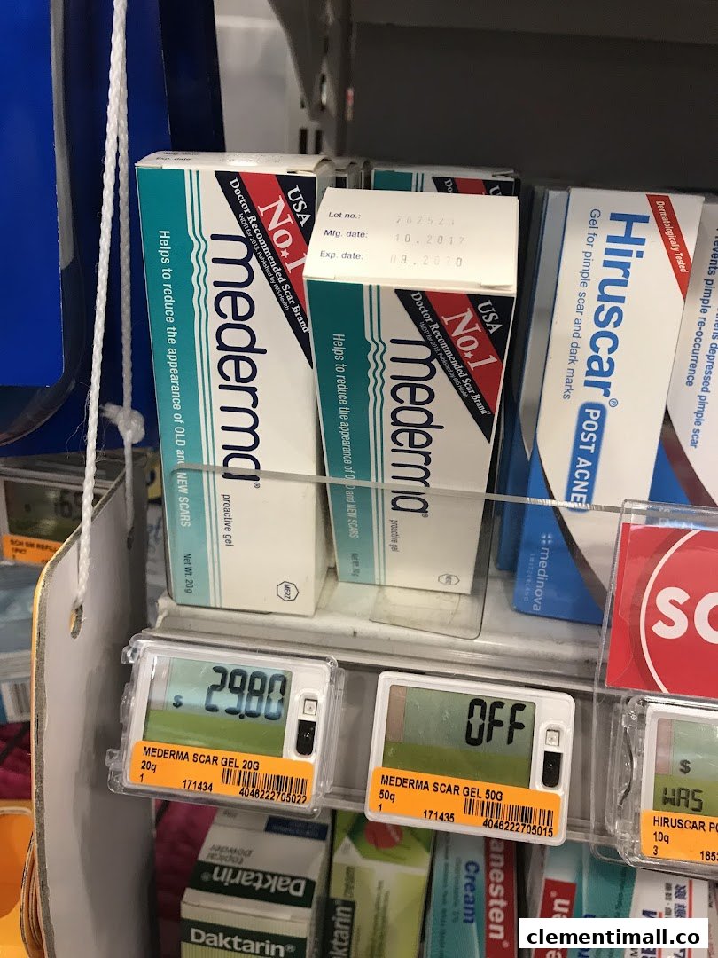 Scar treatment products like Mederma and Hiruscar displayed on a retail shelf with digital price tags.