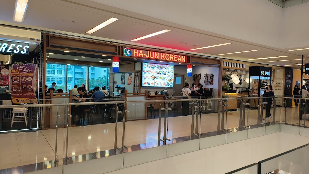 The storefront of Ha-Jun Korean restaurant, showing its entrance and customers dining inside.
