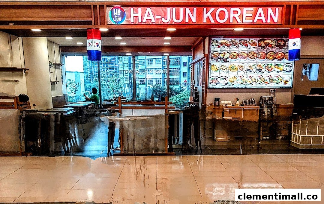 The inviting shop front of Ha-Jun Korean restaurant, featuring a vibrant menu display and comfortable seating.