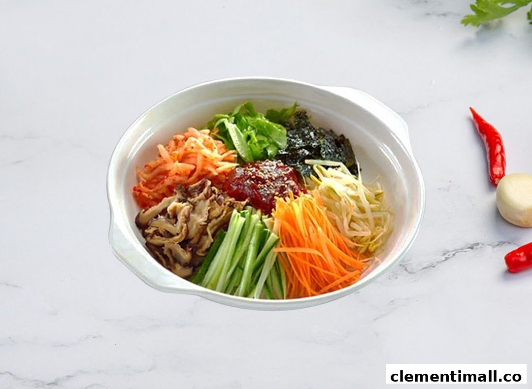 A vibrant bowl of Korean bibimbap featuring various fresh vegetables and gochujang.
