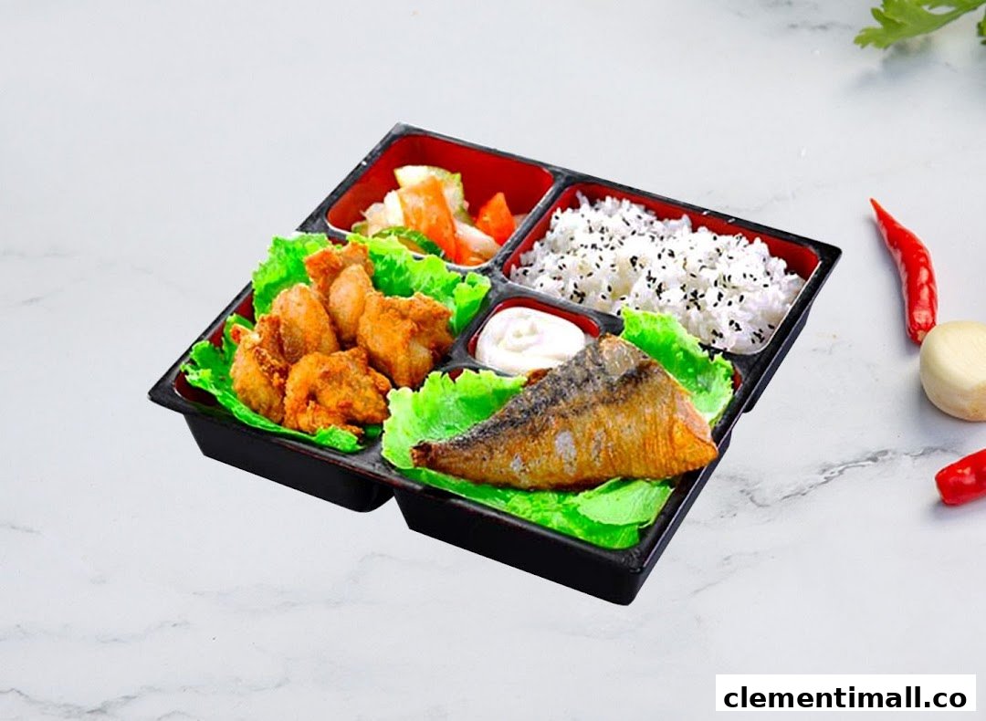 A delicious Korean bento box featuring fried chicken, grilled fish, rice, and pickled vegetables.