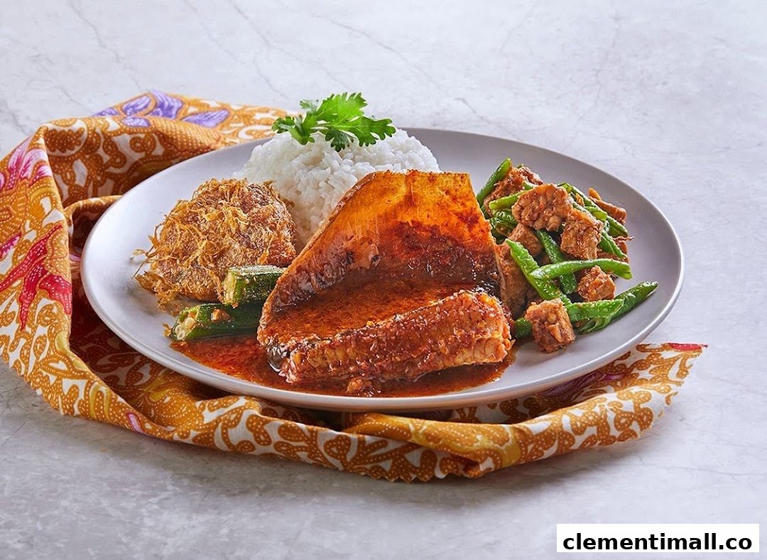 A plate of traditional Malay/Indonesian food featuring rice, fish in curry, fried egg, and stir-fried vegetables.