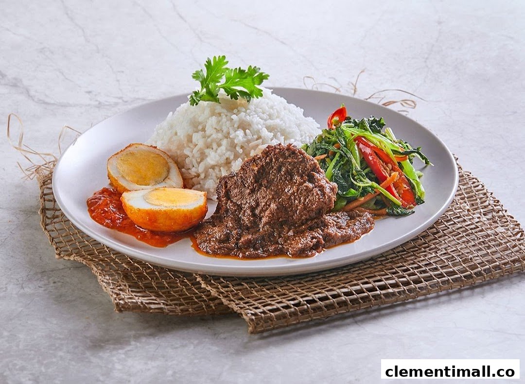 A delicious plate of traditional Malay/Indonesian food featuring rice, beef rendang, fried egg, and stir-fried vegetables.