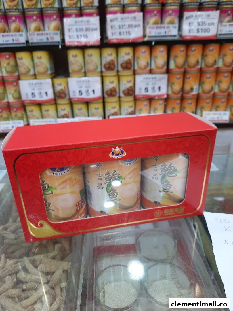 A red gift box of canned abalone displayed in Hockhua Tonic with shelves of various products in the background.