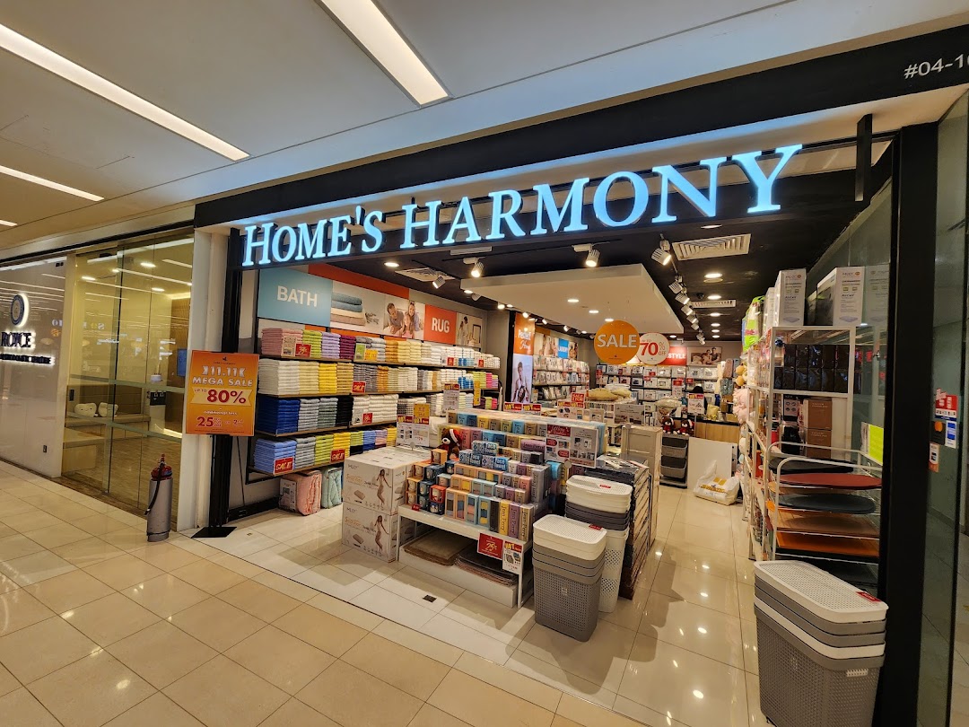 The brightly lit entrance of Home's Harmony, a home goods store, showcasing various products.