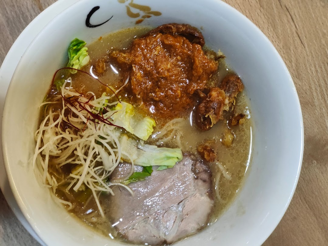 A close-up of a delicious bowl of ramen with rich broth, chashu, and various toppings.