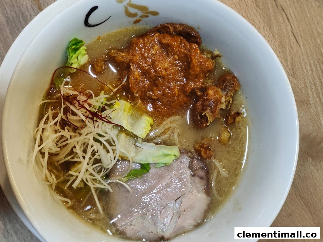A close-up of a delicious bowl of ramen with rich broth, chashu, and various toppings.