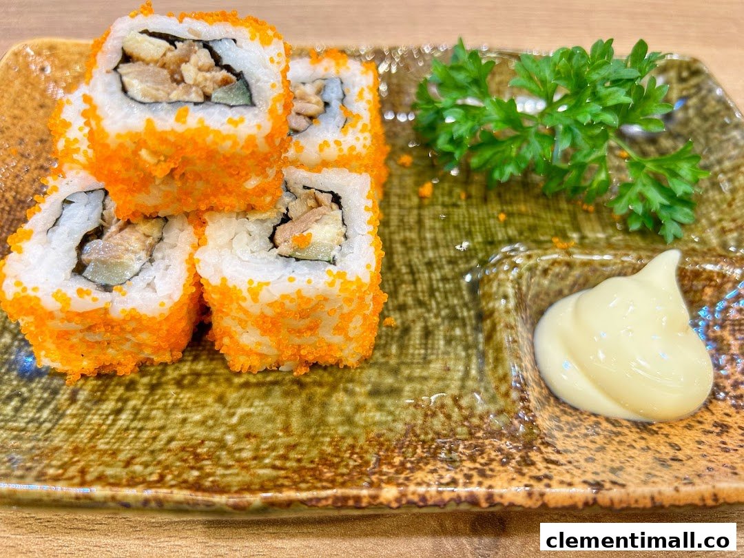 Close-up of vibrant sushi rolls with orange roe, served with mayonnaise and parsley on a rustic plate.
