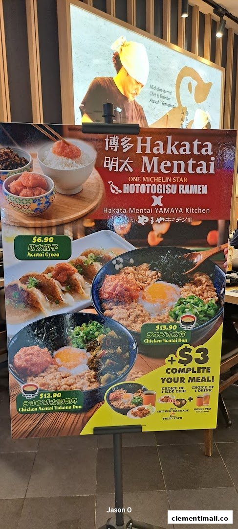 A promotional stand showcasing ramen and donburi dishes with prices and a meal upgrade offer.