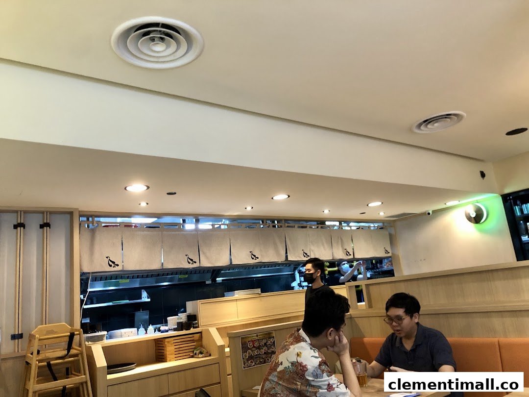 Interior view of Hototogisu Ramen, showing customers dining and the open kitchen area.
