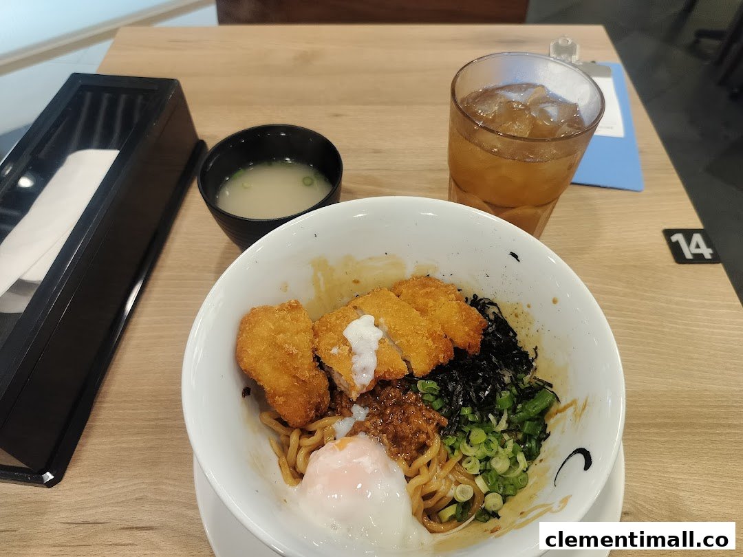 A delicious bowl of ramen with crispy chicken katsu, a poached egg, and various toppings.
