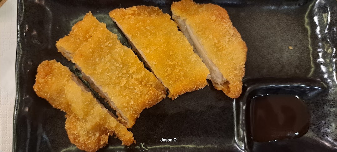 Crispy golden-brown breaded cutlets, likely pork or chicken katsu, served with a dark dipping sauce.