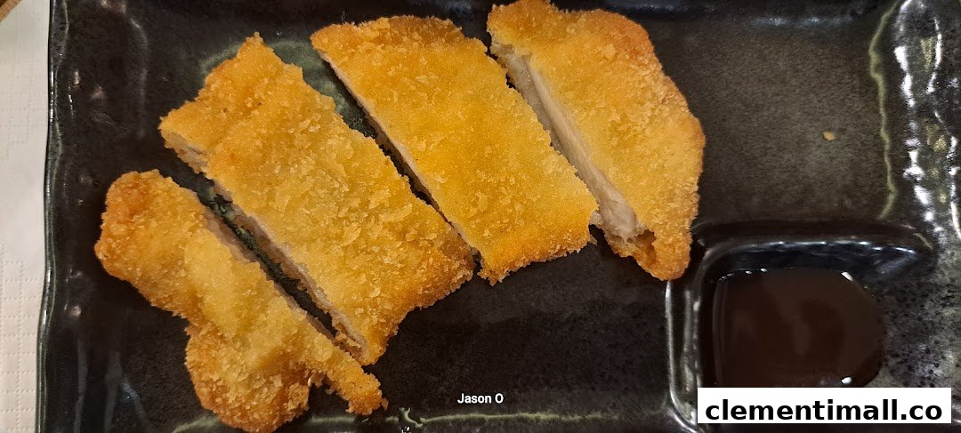 Crispy golden-brown breaded cutlets, likely pork or chicken katsu, served with a dark dipping sauce.