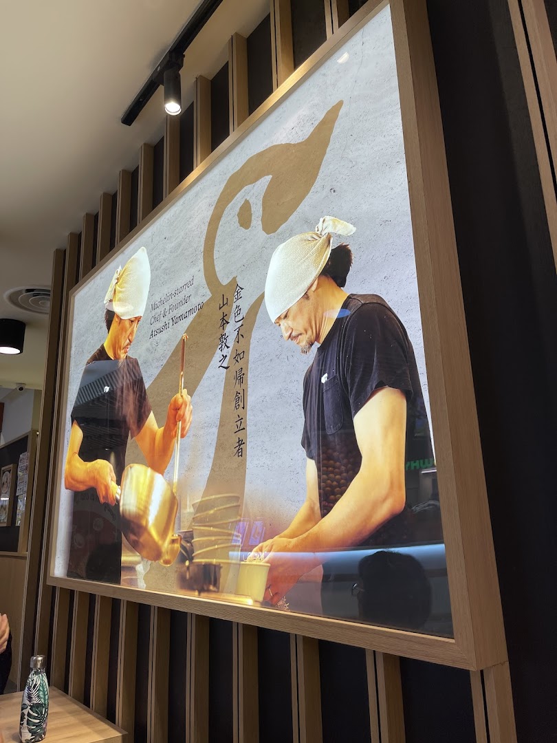 A large framed display inside Hototogisu Ramen featuring Michelin-starred Chef Atsushi Yamamoto.