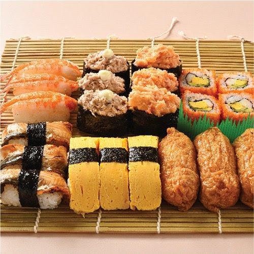 An assortment of fresh sushi and Japanese delicacies, including nigiri, gunkan maki, maki rolls, tamago, and inari.