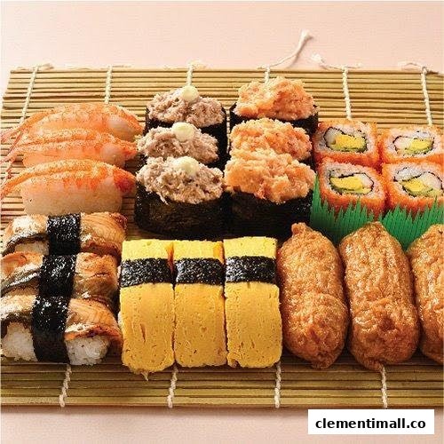 An assortment of fresh sushi and Japanese delicacies, including nigiri, gunkan maki, maki rolls, tamago, and inari.