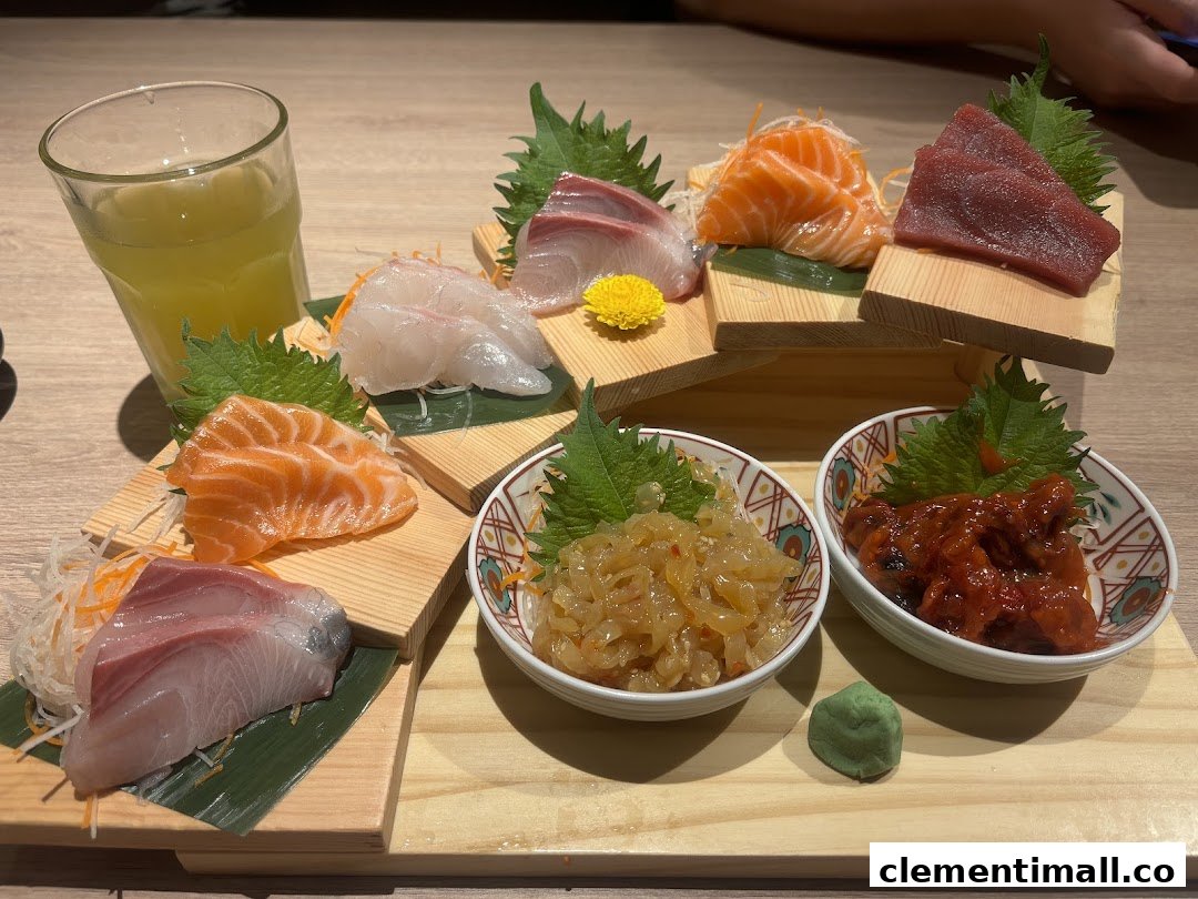 A beautifully arranged platter of fresh sashimi, side dishes, and a drink at Ichiban Boshi.
