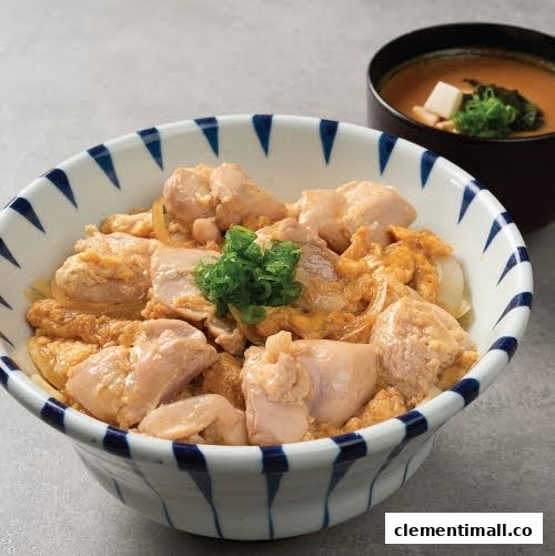 A delicious Japanese Oyakodon (chicken and egg rice bowl) served with a side of miso soup.