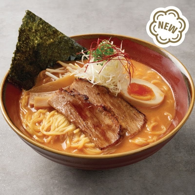 A close-up of a delicious bowl of ramen with chashu, egg, and seaweed, marked as 'NEW'.