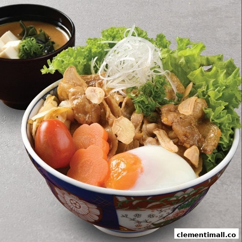 A vibrant Japanese rice bowl featuring tender meat, fresh vegetables, a poached egg, and a side of miso soup.