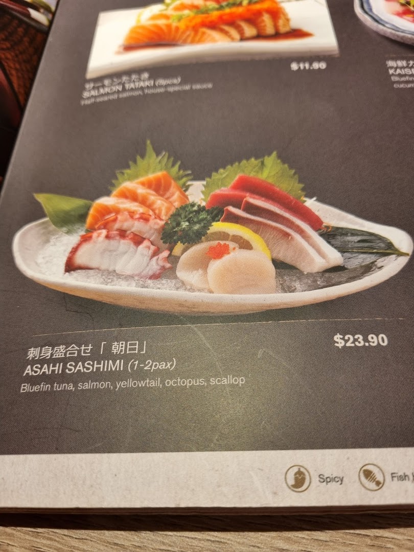A close-up of a Japanese restaurant menu featuring fresh sashimi and salmon tataki dishes with prices.