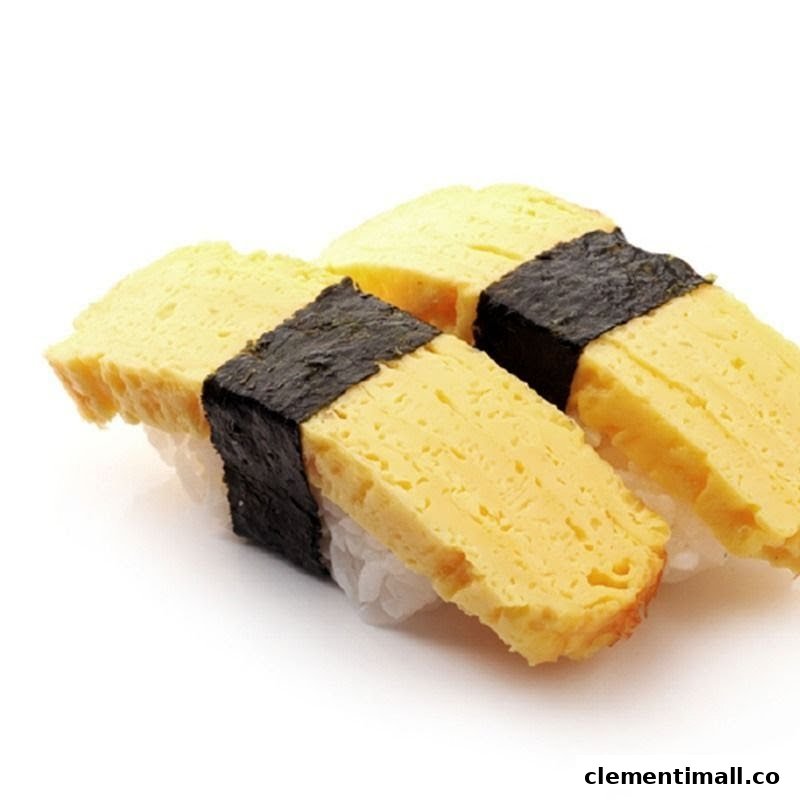 Two pieces of tamago (egg) sushi with seaweed on a white background.