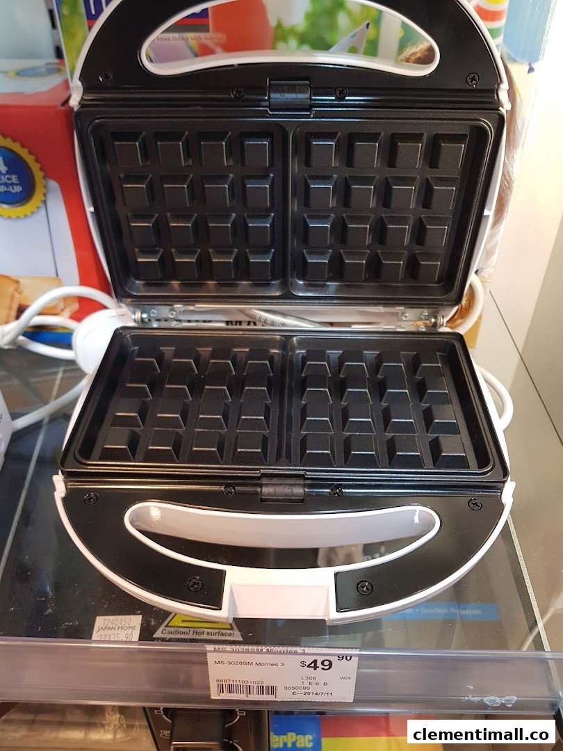 An open white waffle maker with a price tag is displayed in a Japan Home store.