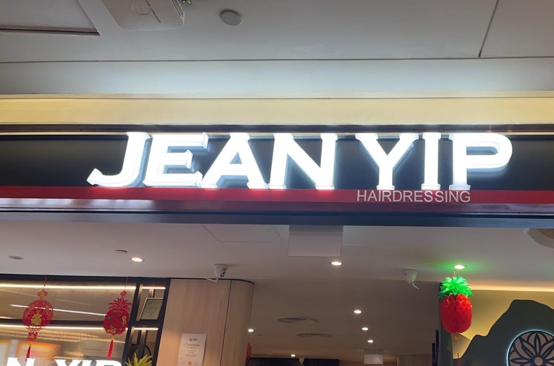 The illuminated sign for Jean Yip Hairdressing at Clementi Mall, showcasing its entrance.