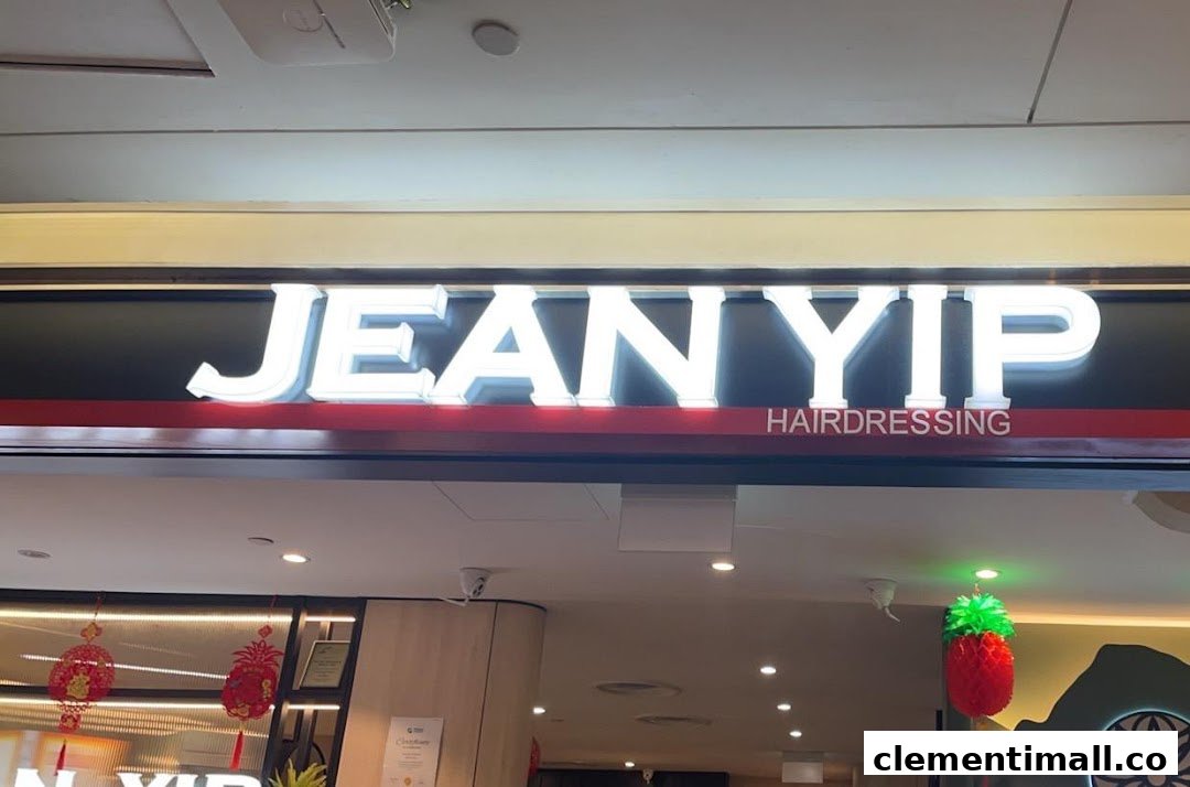The illuminated sign for Jean Yip Hairdressing at Clementi Mall, showcasing its entrance.