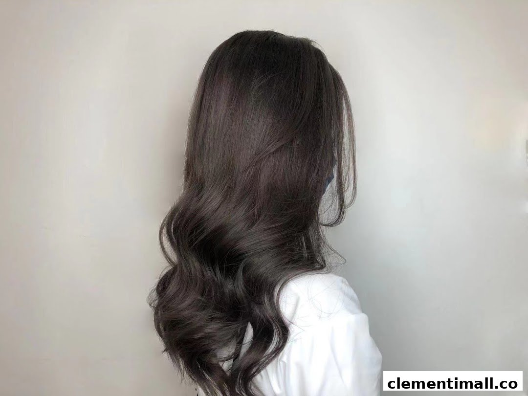A person showcasing long, dark, wavy hair, likely a result of styling at Jean Yip Hairdressing.